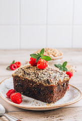 Delicious portion-sized brownie made from green buckwheat and cup of coffee over rustic wooden background, Gluten free, vegan-friendly concept. Selective focus