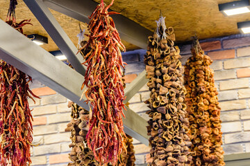 Dried aubergines and peppers hanging in spice shop at turkish bazaar market