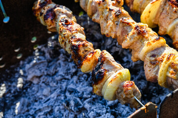 Marinated shashlik (or shish kebab) preparing on a skewers over charcoal