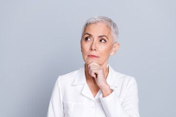 Photo of charming qualified specialist doctor woman hand chin wear white robe look empty space...