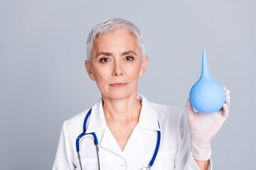 Photo of attractive beautiful woman qualified specialist therapist hand hold old enema therapy...