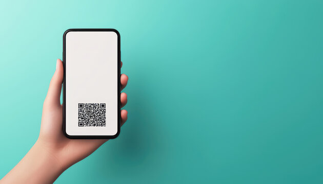 Close-up of a hand holding a smartphone displaying a QR code on a turquoise background. Ideal for technology and business themes.