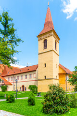 Fototapeta premium The former chapel of Saint Anne stands proudly in Tramin, surrounded by green space and trees. Blend of history and nature, offering a peaceful atmosphere in the heart of Cesky Krumlov, Czechia