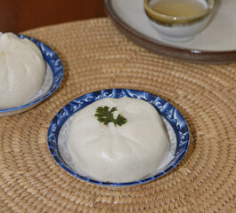Stuffed steamed bun at dish on table