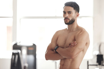 Arms crossed, exercise and portrait of shirtless man in boxing gym for challenge, self defense or sports training. Body, fitness and wellness with confident athlete in health club for workout