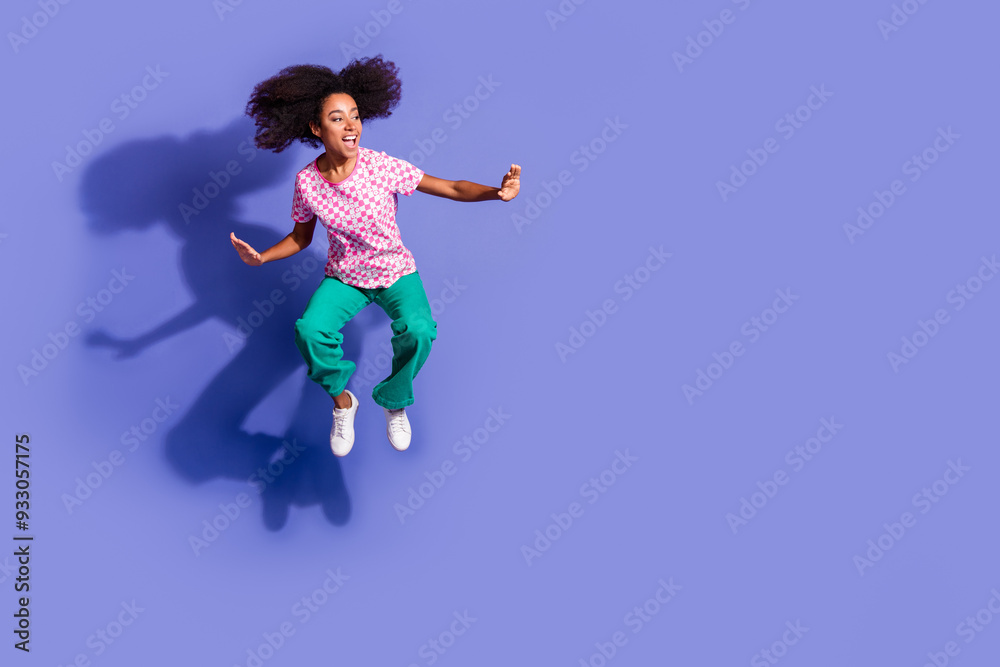 Sticker Full body photo of attractive young woman jump surfing look empty space dressed stylish pink clothes isolated on violet color background