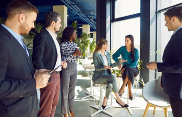 Office diverse business colleagues gathering in boardroom hall, female coworkers brainstorm to discuss together, happy multiracial workers cooperating working together at meeting, friendly teamwork 