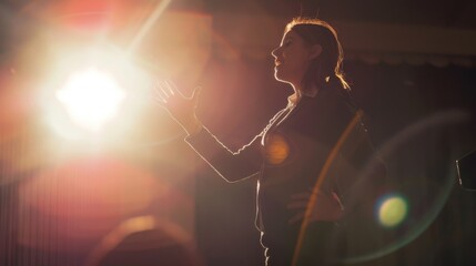 A woman passionately speaks at a podium with lens flares from the bright light creating an inspirational scene.