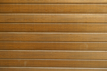 Front view of brown faux wood exterior panel siding