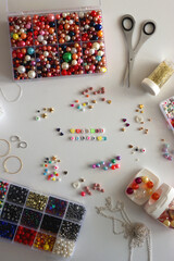 Friends forever written with colorful beads. Jewelry making supplies on the table. Making friendship bracelets concept. Flat lay.