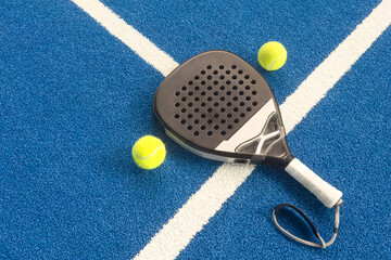 padel racket on a padel blue court with a ball