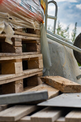 Various building materials and fixtures near a house under construction
