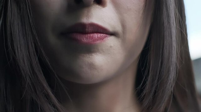 Closeup of young woman's mouth complaining