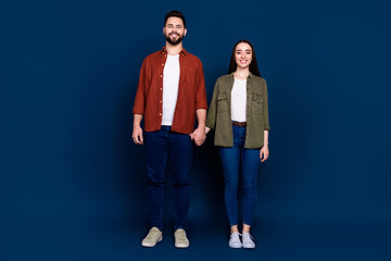 Obraz premium Photo of cheerful lovely nice couple wife husband wear stylish clothes honeymoon isolated on dark blue color background