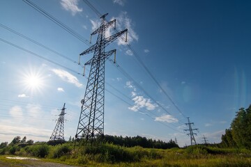 World Energy Day. Ukraine energy crisis. Electrical net of poles on a panorama of blue sky and green meadow. Estonia