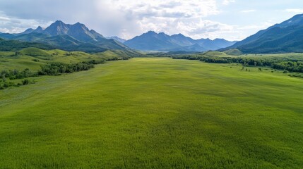 Obraz premium Scenic mountain landscape with golden grass in a valley under a bright blue sky