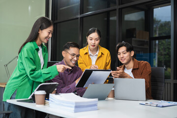 Group of Young Asian business team creative businesspeople coworker in office Happy to be successful partnership teamwork success concept.