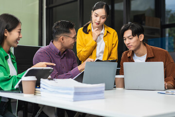 Group of Young Asian business team creative businesspeople coworker in office Happy to be successful partnership teamwork success concept.