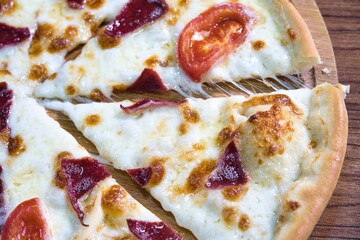 Closeup of Pizza With Cheese, Tomato, and Meat