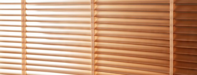 Warm orange light filters through wooden blinds at night, casting shadows in a cozy room