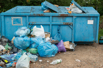 bags of garbage standing by the garbage can. the ecological problem of garbage