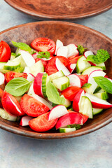 Salad bowl filled with various fresh vegetables