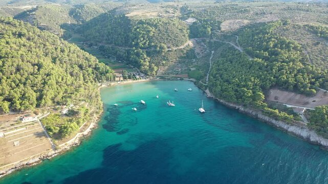 Drone Footage of Lovrecina Beach on Brac Island, Croatia Capturing Crystal Clear Waters and Lush Green Surroundings