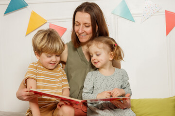 Mom and kids share happy moments of reading stories together