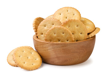 Round crackers in a wooden plate and scattered on a white background. Isolated