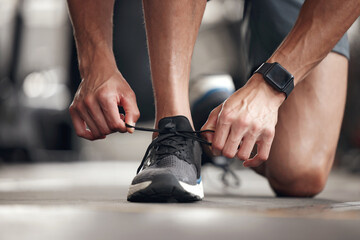 Hands, person and tie shoes at gym for exercise preparation, start workout and training sneakers of...