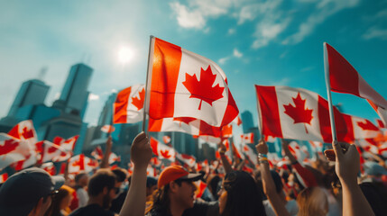 People holding the national canadian flags in the Canada Day parade against a blue sky background