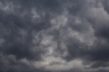 Dark, stormy clouds dominate the sky, moody sky, dramatic sky, overcast sky, stormy weather, cloud formation