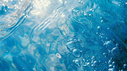 Obraz premium Transparent blue clear water surface texture with ripples, splashes and bubbles. Abstract summer banner background Water waves in sunlight with copy space Cosmetic moisturizer micellar toner emulsion.