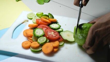 Fruits salad slice with knife on chopping board