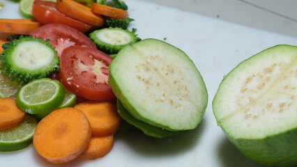 Fruits salad slice with knife on chopping board