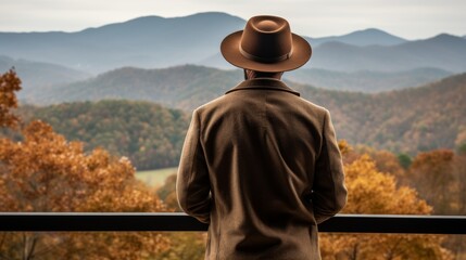 Man captivated by the mesmerizing beauty of the stunning autumn mountain range landscape