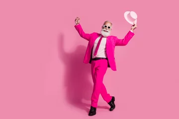 Fotobehang Full body photo of elderly white hair santa man dancing mc showman sunglass hold hat wear stylish pink suit isolated over pastel background © deagreez