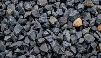 Close-up of a pile of grey gravel with a few tan stones.