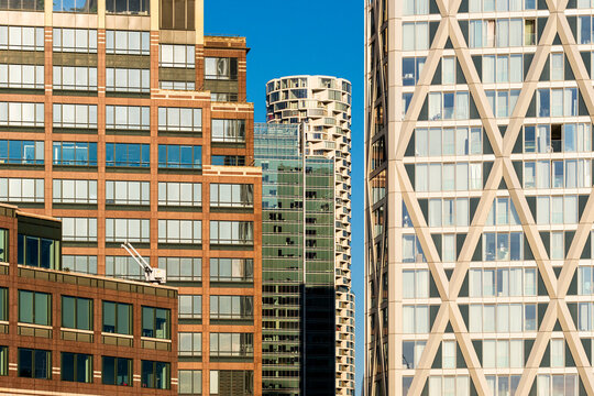 A diverse collection of modern buildings showcases different architectural styles in a bustling city, representing urban expansion and creative construction approaches in London England