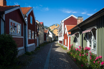 Old town in Sweden, Cozy street with traditional colorful timber houses in Gamla Gefle quarter of Gävle city on summer sunny day