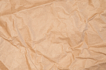 Fototapeta premium Craft wrapping paper texture of flat crumpled sheet of cellulose products. Old tattered page surface background. Eco-friendly empty aged recyclable packaging