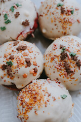 Donuts with white icing and colored sprinkles