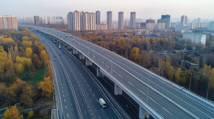 Fototapeta premium Aerial view of a multi-lane highway in the city with high rise apartment buildings on each side.
