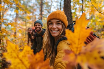 Friends Hiking Through a Golden Wonderland - A radiant young woman beams at the camera, framed by vibrant autumn leaves, as she and her friends hike through a sun-dappled forest