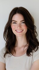 Naklejka premium A professional headshot of a smiling woman with a crisp white background, her eyes exuding confidence and warmth
