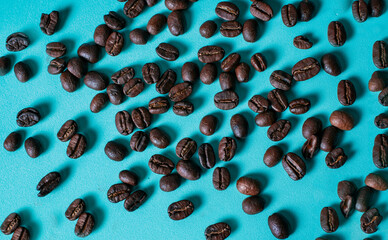 Roasted coffee bulks isolated. Roasted coffee beans on light blue background