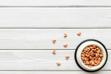 Food and treats for pets - biscuits in a shape of heart in a bowl