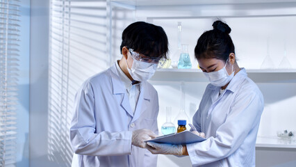 Scientists standing in white background laboratory and discussing about the result of science experiment. Front view advertising photo, blank space for designing