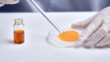 Close up shot in scene of scientist conducts a chemical experiment in laboratory, carefully stir...