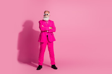 Full length photo of serious old cool man gentleman boyfriend crossed hands confident wear sunglass pink suit isolated pastel background